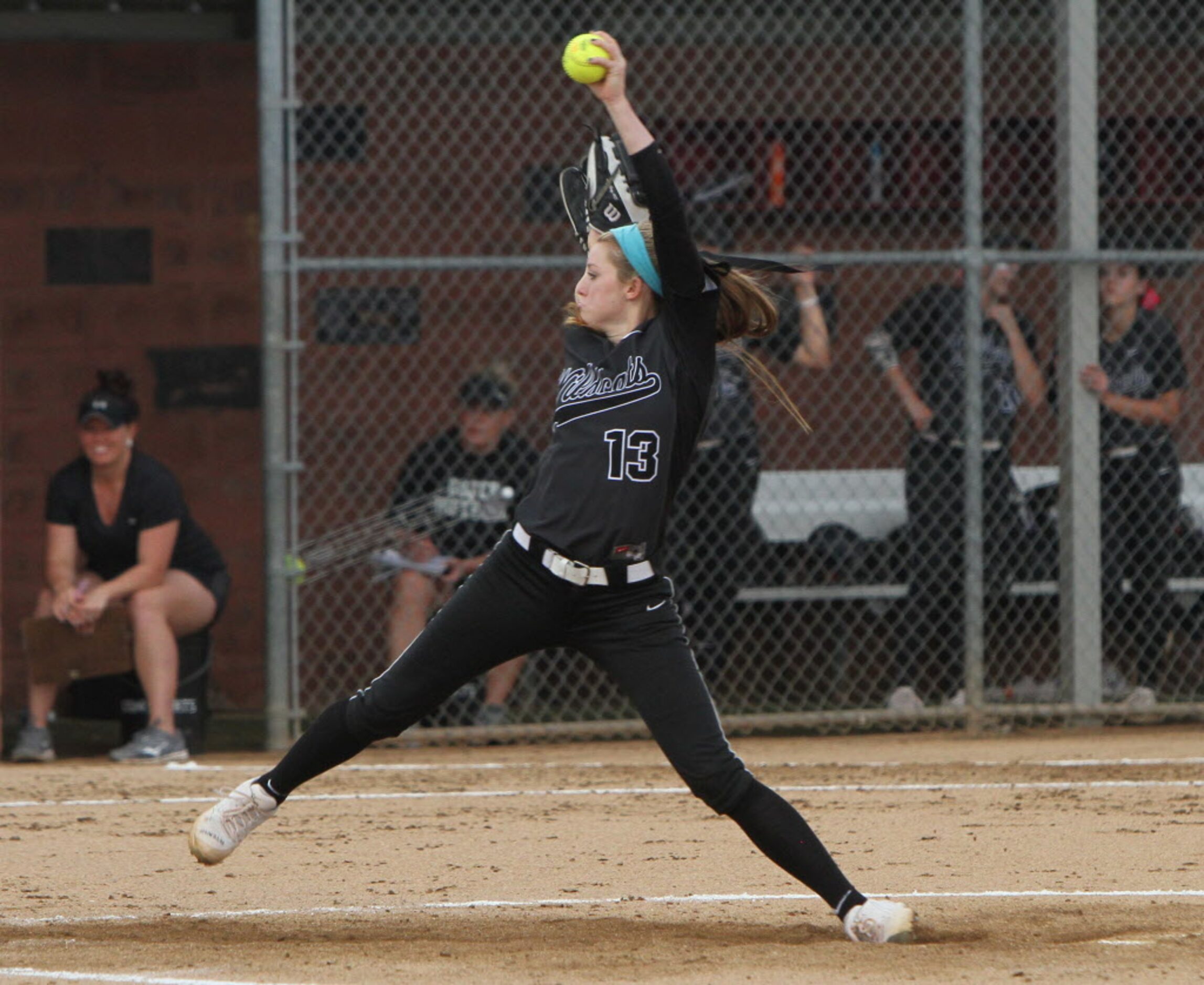 Under the watchful eye of the team bench, Denton Guyer pitcher Shayne Starkey (13) delivers...