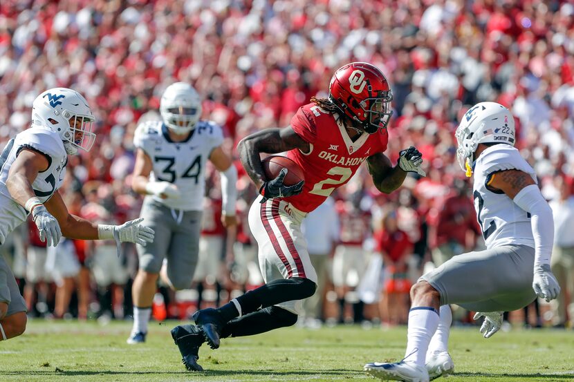 FILE - Oklahoma wide receiver CeeDee Lamb (2) runs for a first down against West Virginia...