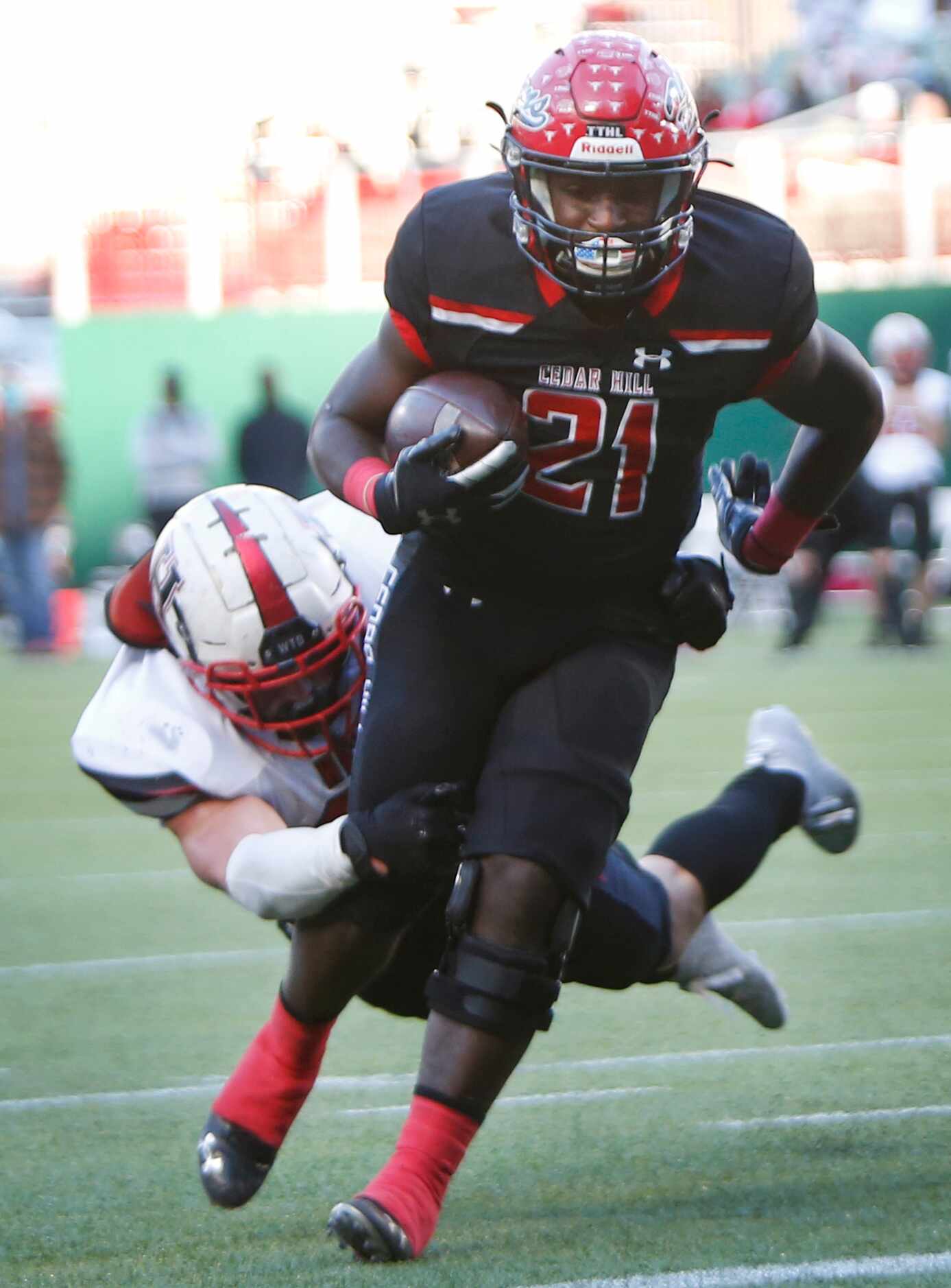 Cedar Hill running back Kris Allen (21) pulls away from the diving attempted tackle of...