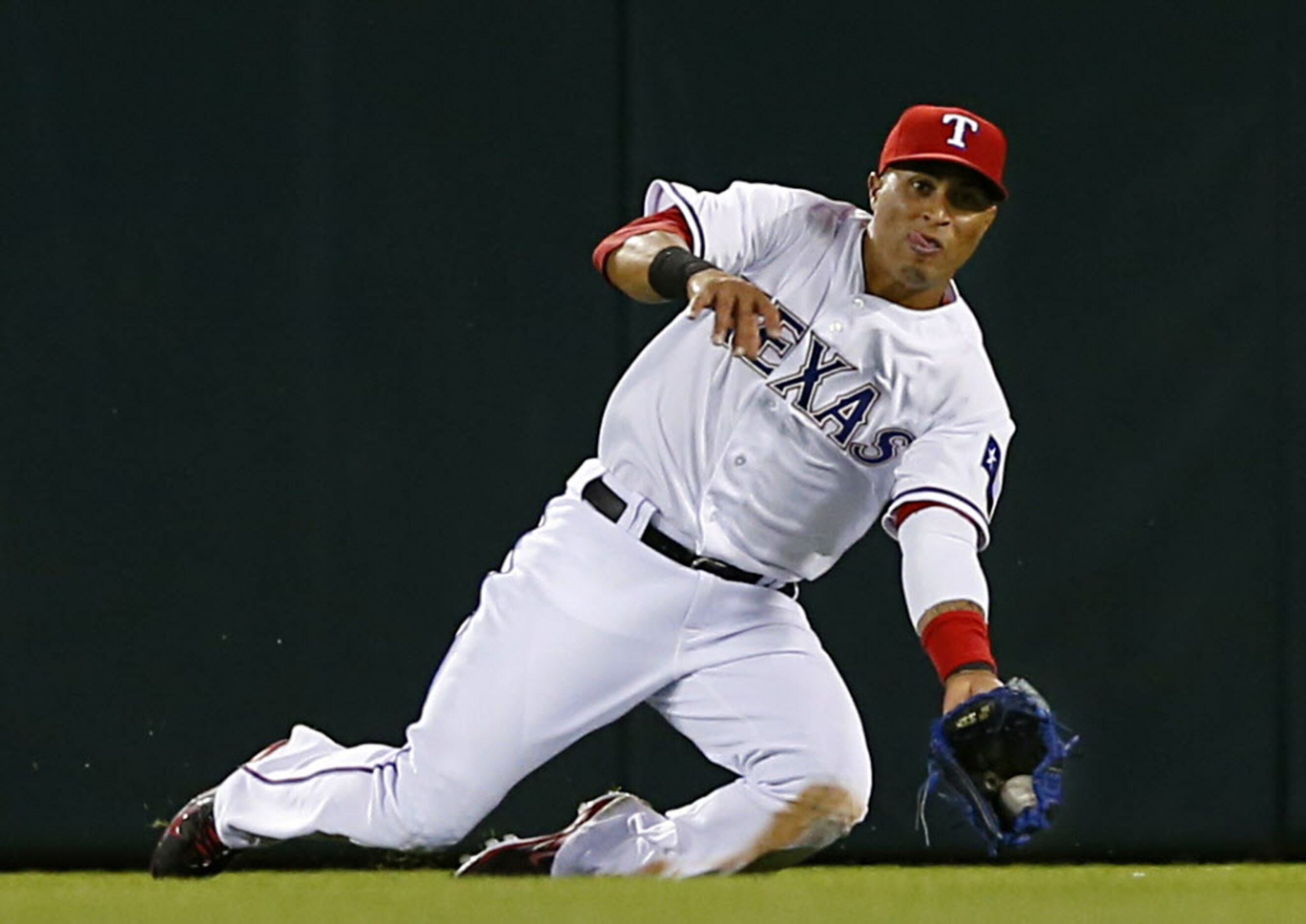 Texas Rangers center fielder Leonys Martin (2) lunges at a  fly ball by Houston Astros...