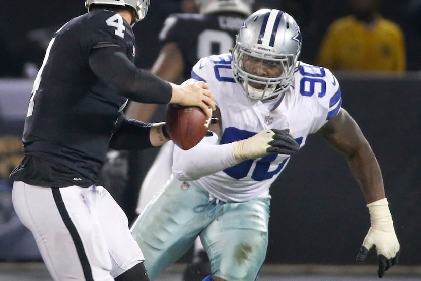 Dallas Cowboys defensive end Demarcus Lawrence (90) rushes Oakland Raiders quarterback Derek...