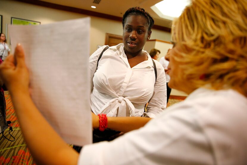 Eboni Parker talks to LeeAnn Stanley with Workforce Solutions Greater Dallas during the...