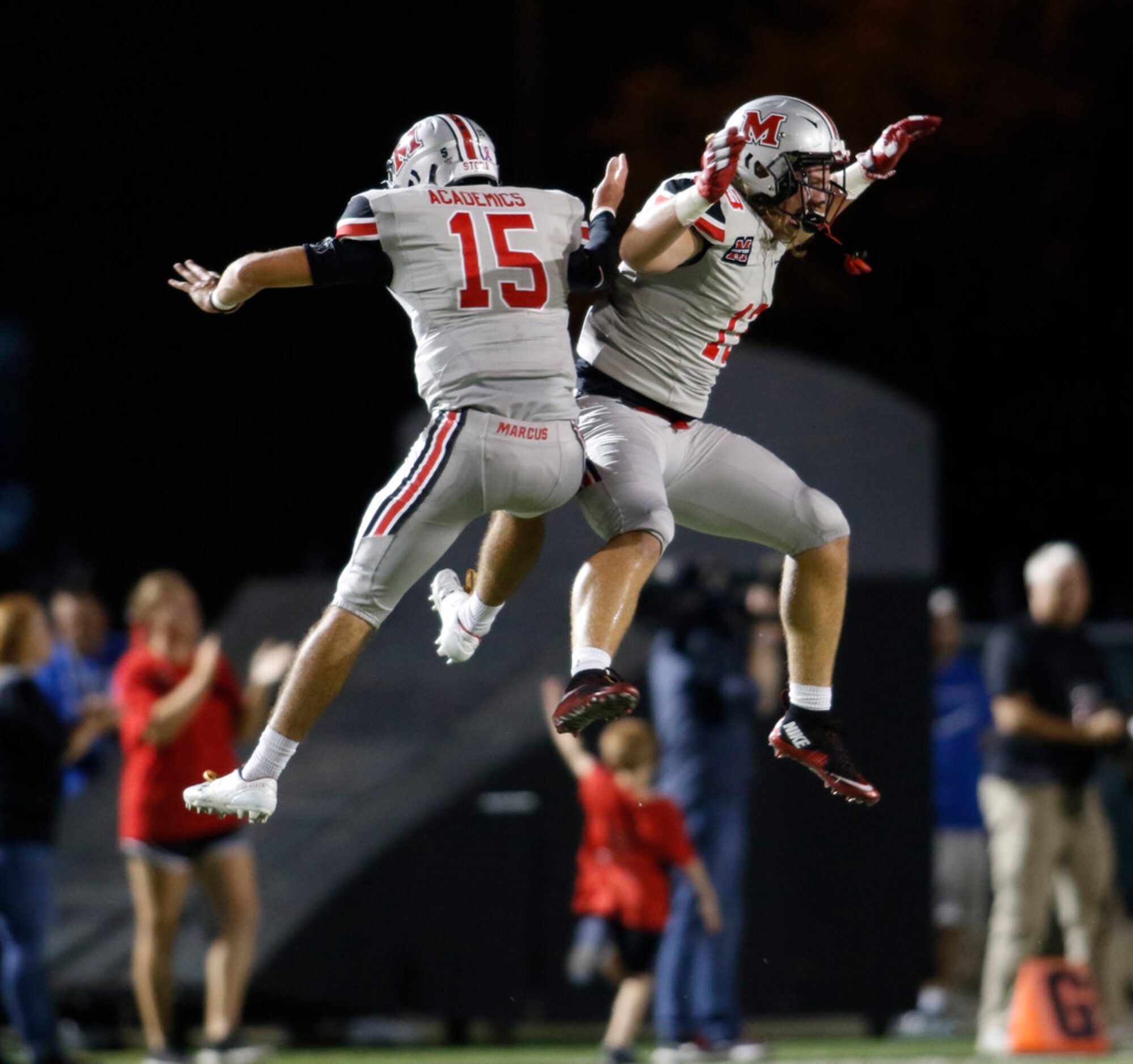 Flower Mound Marcus quarterback Xavier Maxwell (15) skies with teammate Gage Anderson (13)...