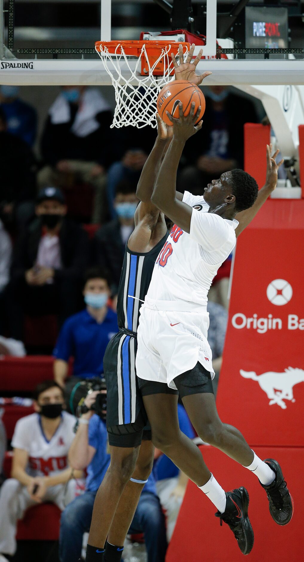 SMU forward Yor Anei (10) attempts a layup as Memphis center Moussa Cisse (32) defends...