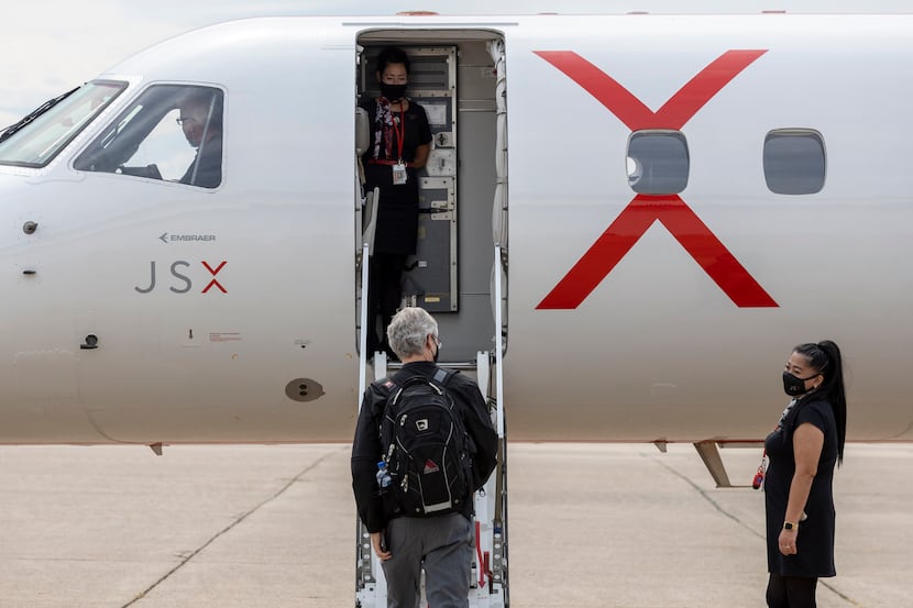 A JSX crew member greeted a passenger as he boarded at Dallas Love Field in 2021. (Elias...
