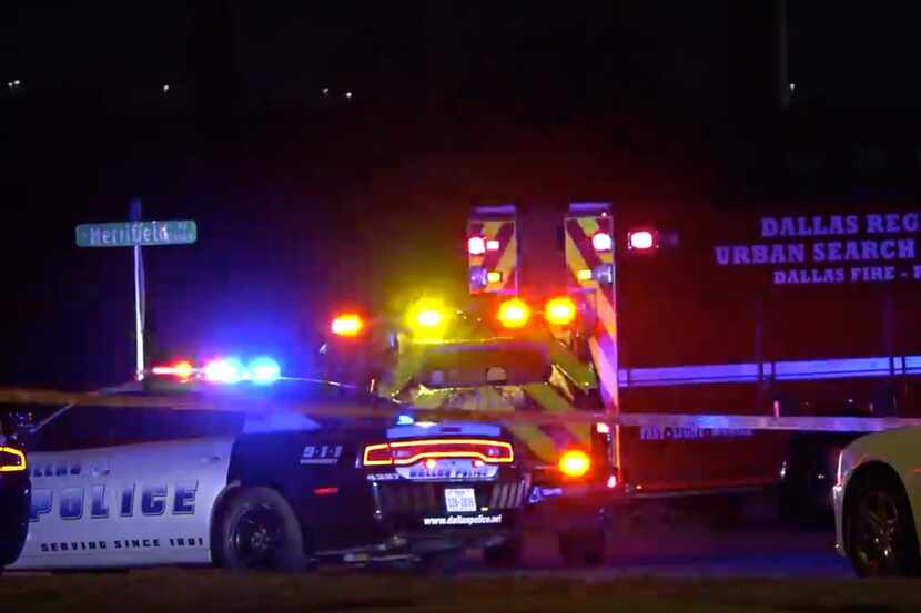 A Dallas police car and a Dallas Fire-Rescue ambulance at the scene of a fatal crash late...