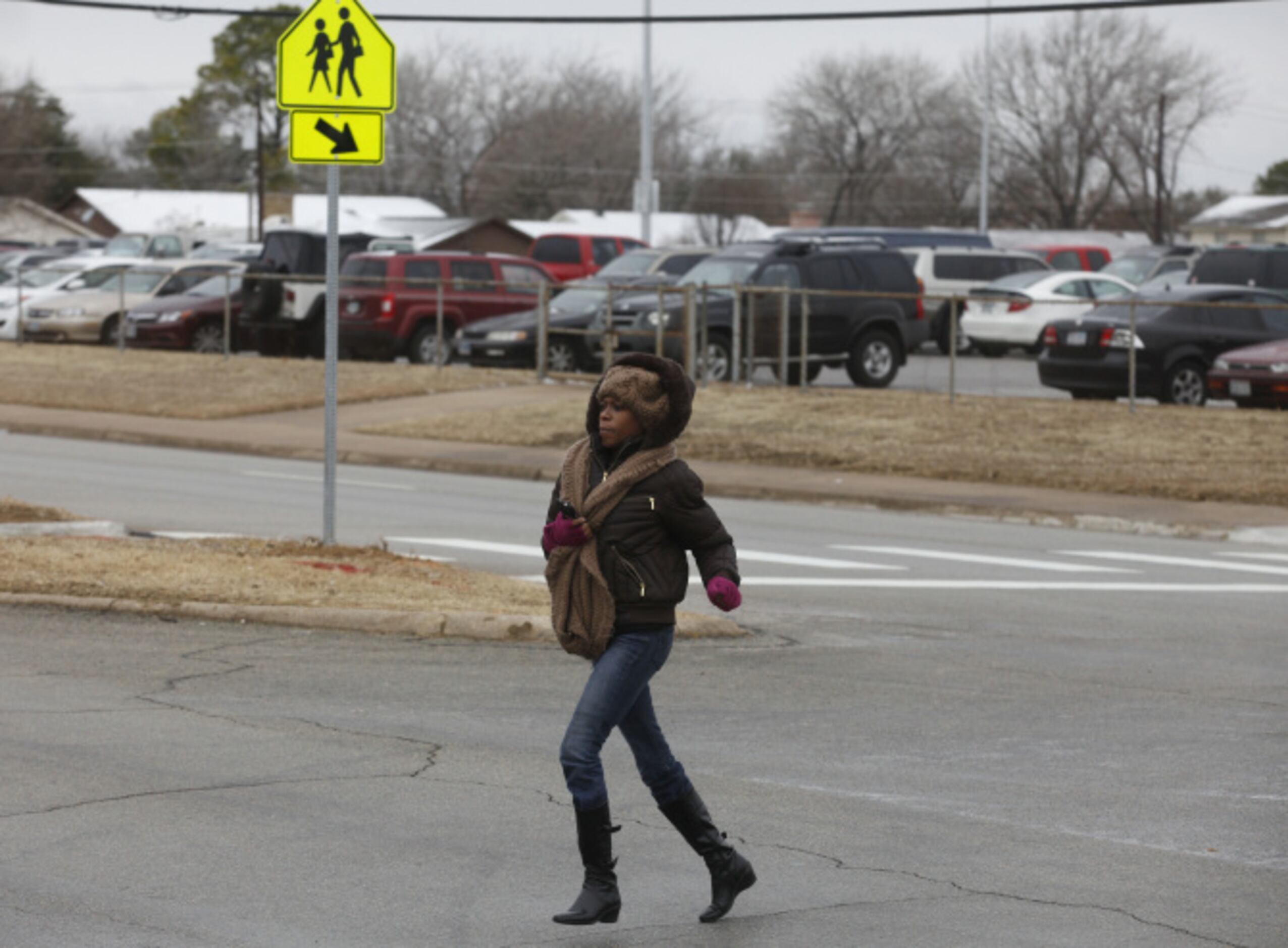 Parent Latonya Davis runs to Lamar High School as she tries to get information during a...
