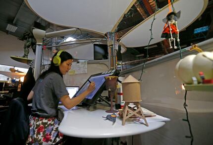 Art director Ruby Wang works on game characters at Flight School Studios, a video game...