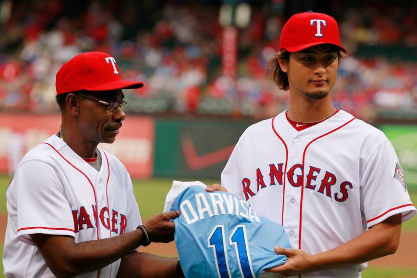 Texas Rangers manager Ron Washington (38) presents Texas Rangers starting pitcher Yu Darvish...