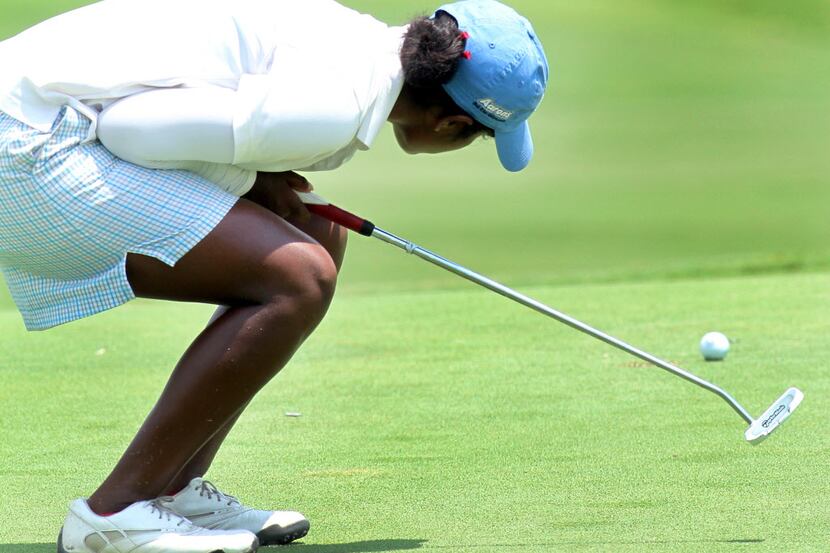 Chaithra Katamneni, the eventual tournament winner, reacts after her putt on the 16th green...