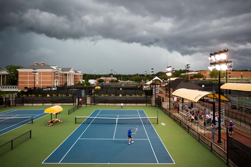 Storm clouds roll over the 4A boys state championship tennis match between Madison's ...