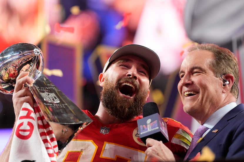 Kansas City Chiefs tight end Travis Kelce (87) celebrates while holding the Vince Lombardi...