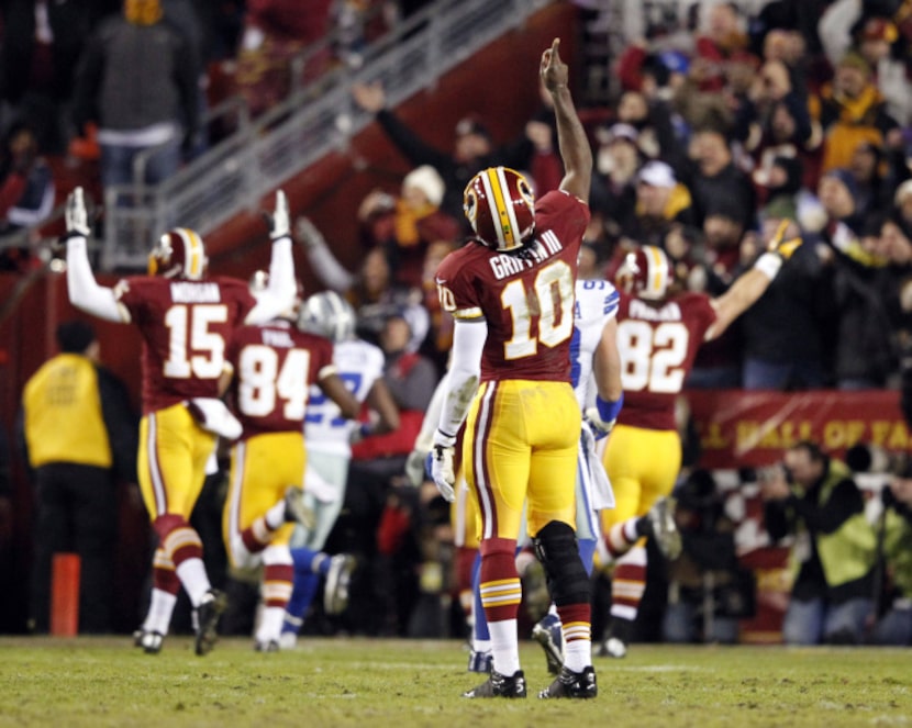 Washington Redskins quarterback Robert Griffin III (10) celebrates as Washington Redskins...