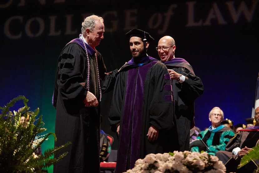 Law student Rafael Valbuena stands on stage during UNT-Dallas' first Juris Doctor hooding...