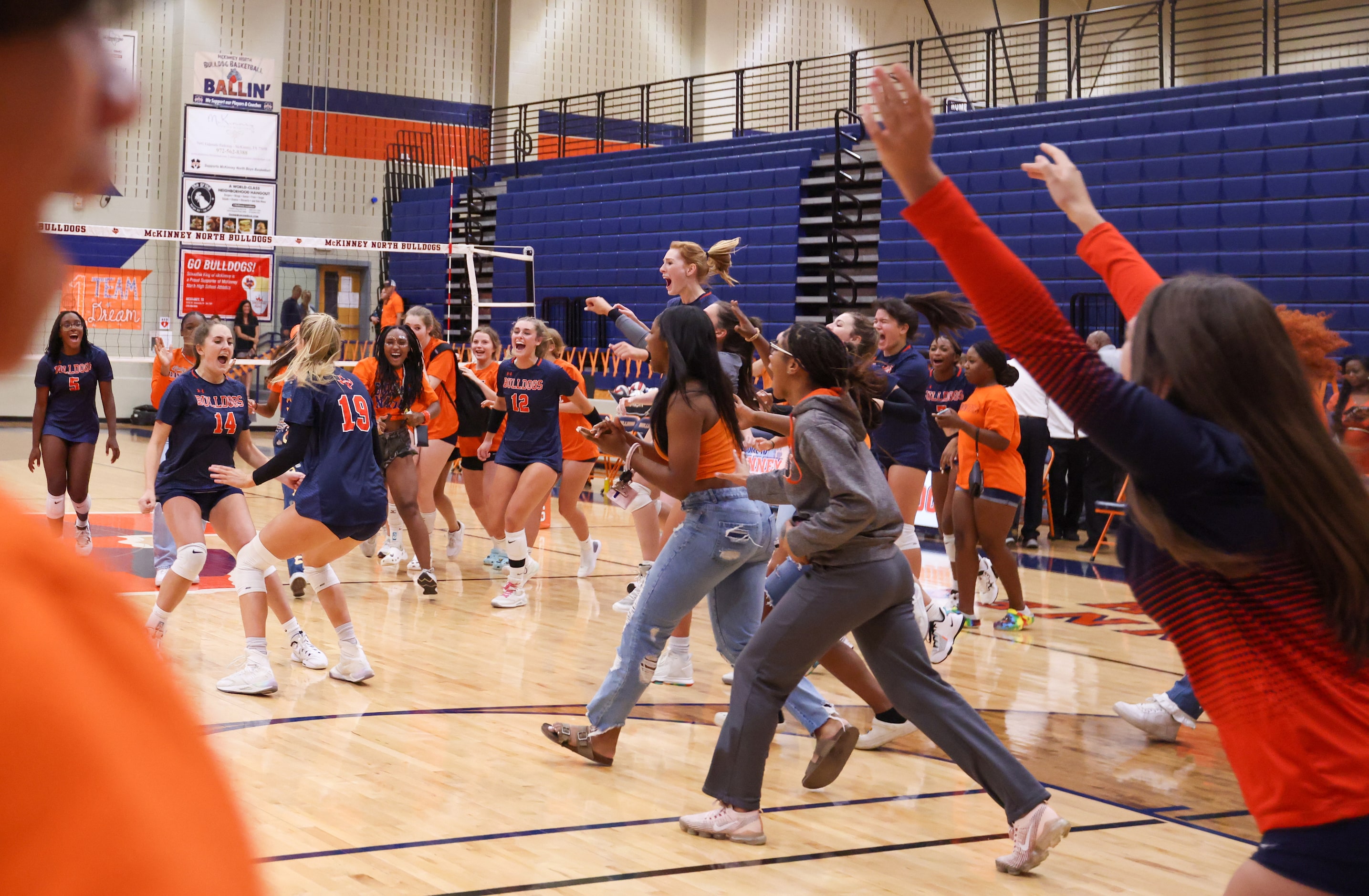 McKinney North Brooke Butler (14) and Natalie Hughes (19) pause before jumping to celebrate...