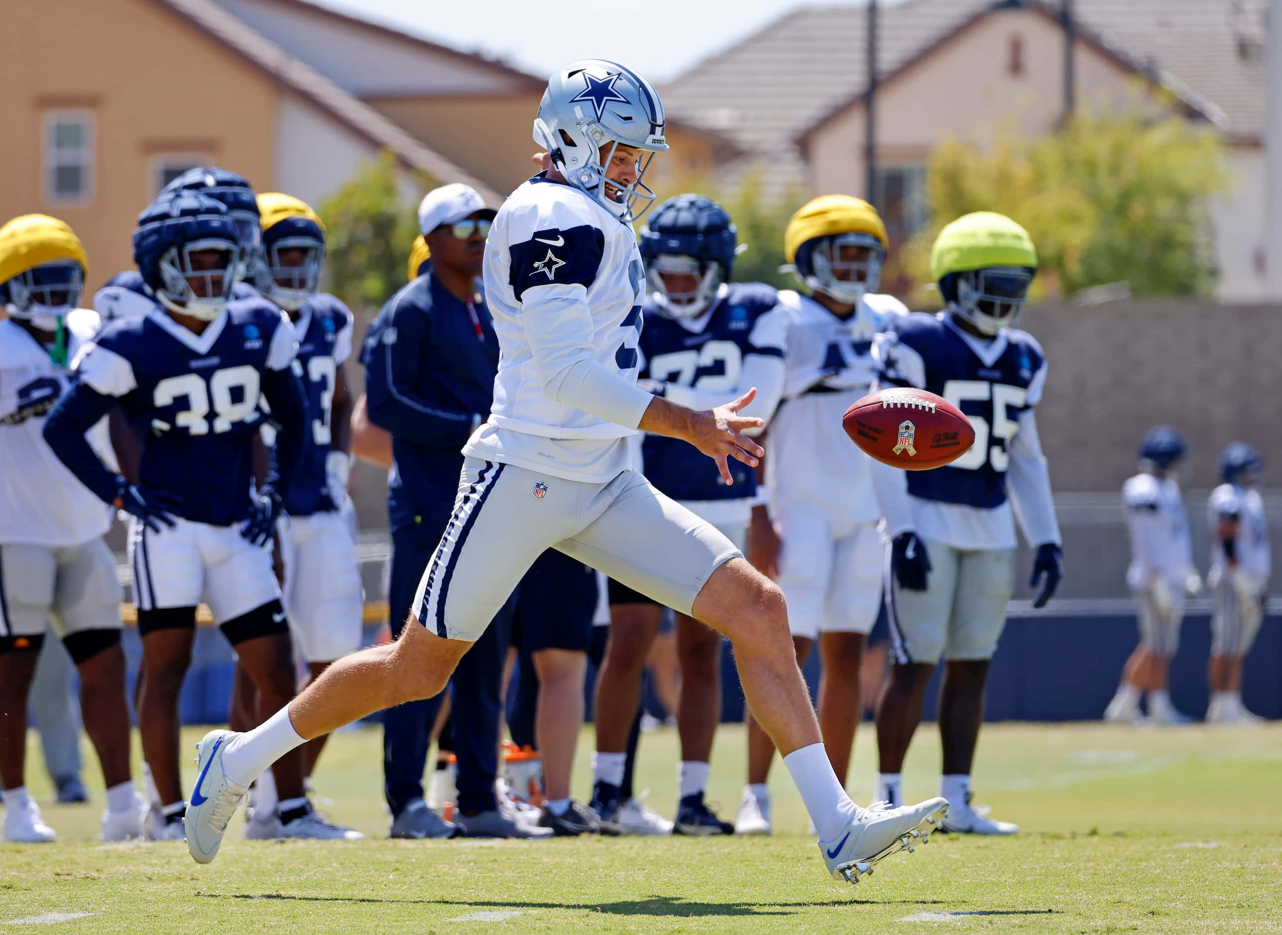 Dallas Cowboys punter Bryan Anger (5) kicks the ball during special teams plays at training...