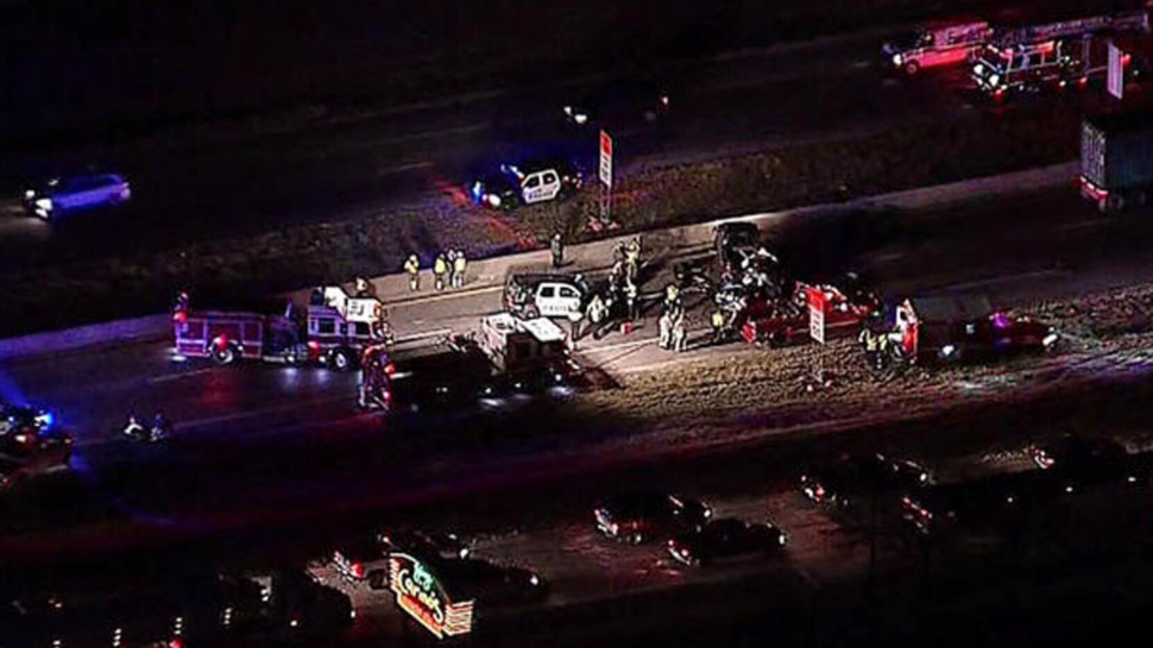  Police and firefighters work the scene of a crash early Thursday on Interstate 35E in...