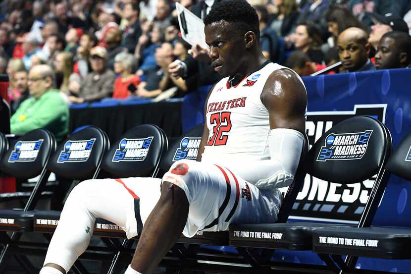 TULSA, OKLAHOMA - MARCH 24:  Norense Odiase #32 of the Texas Tech Red Raiders sits on the...