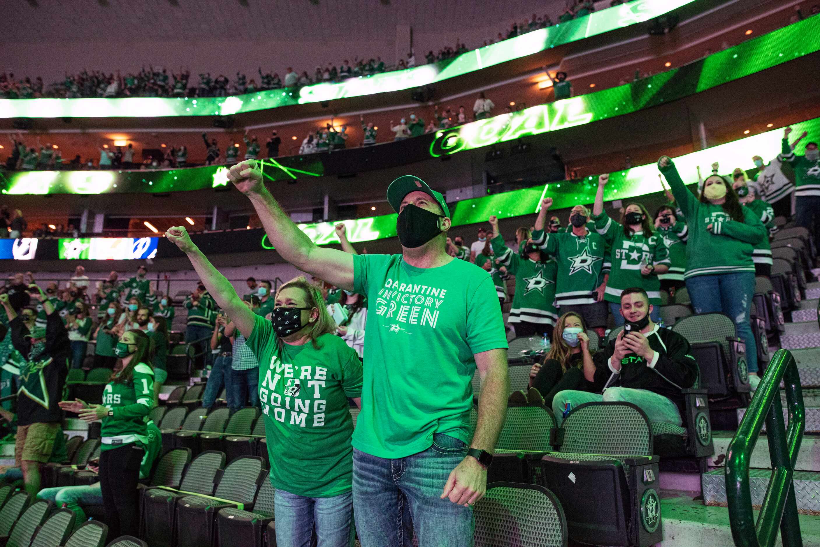 Charisse Dunn, left, and Kevin Dunn, of Coppell, pump their fists in the air chanting Stars...