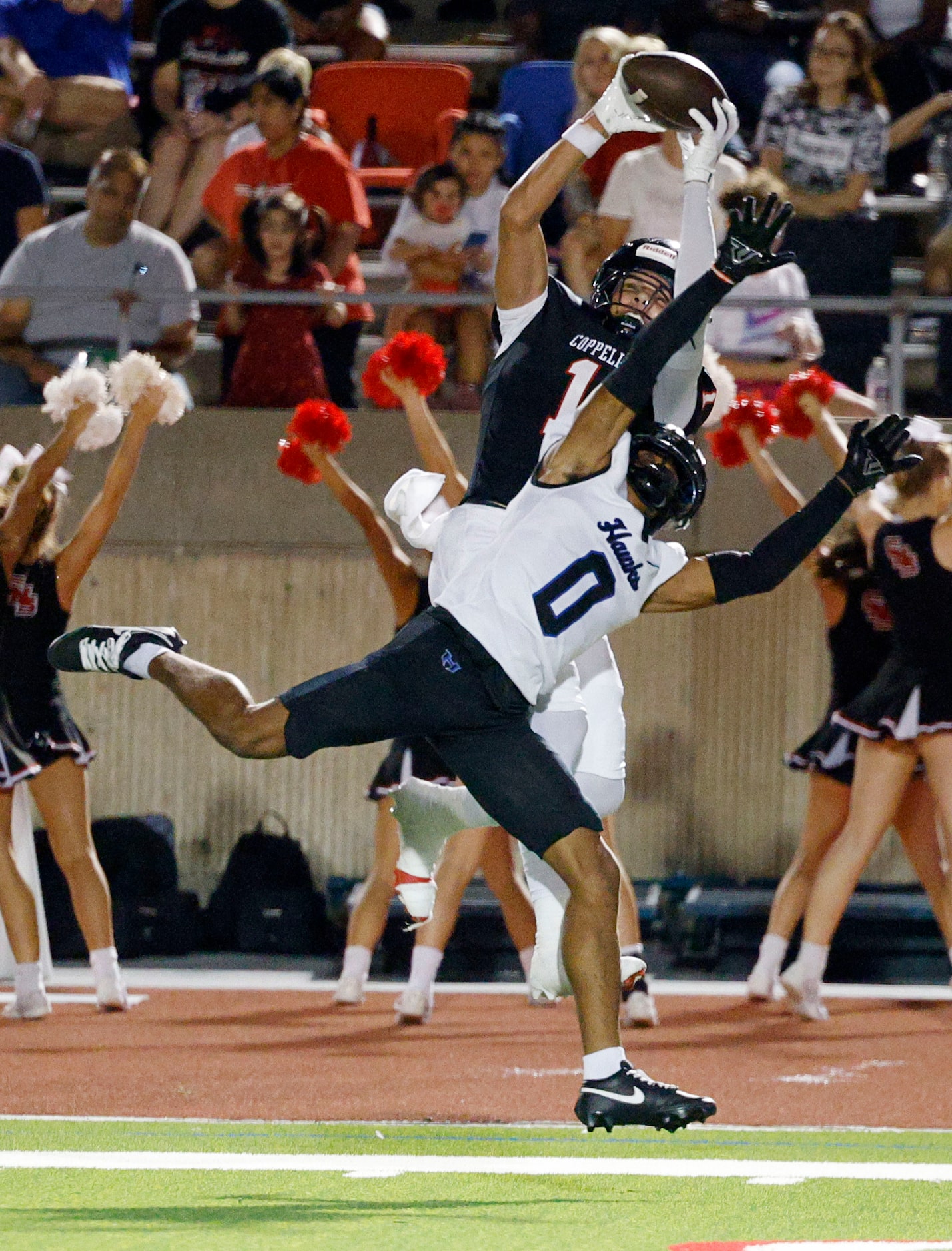 Coppell's Tucker Cusano (1) catches a pass against Hebron's Gabriel White (0) and runs for a...