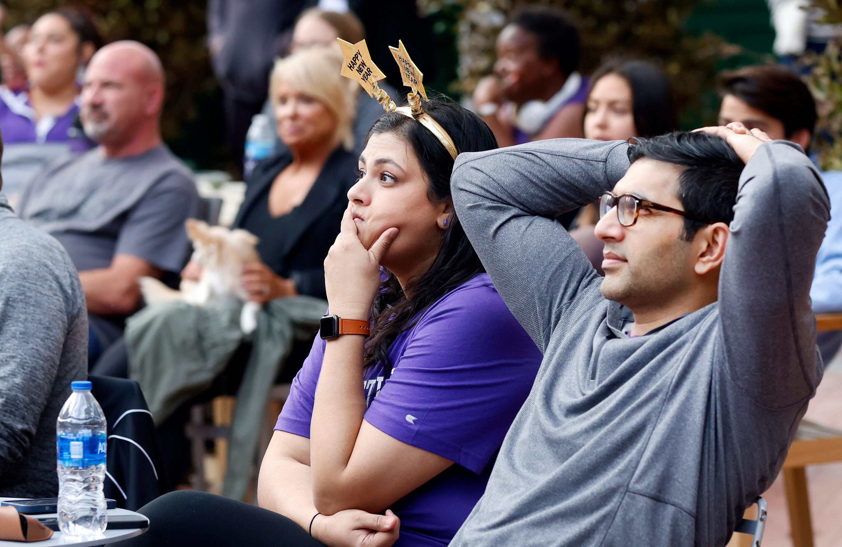 TCU Horned Frogs alums Wardah Iqbal (left) and her husband Azeem Iqbal watch their team play...