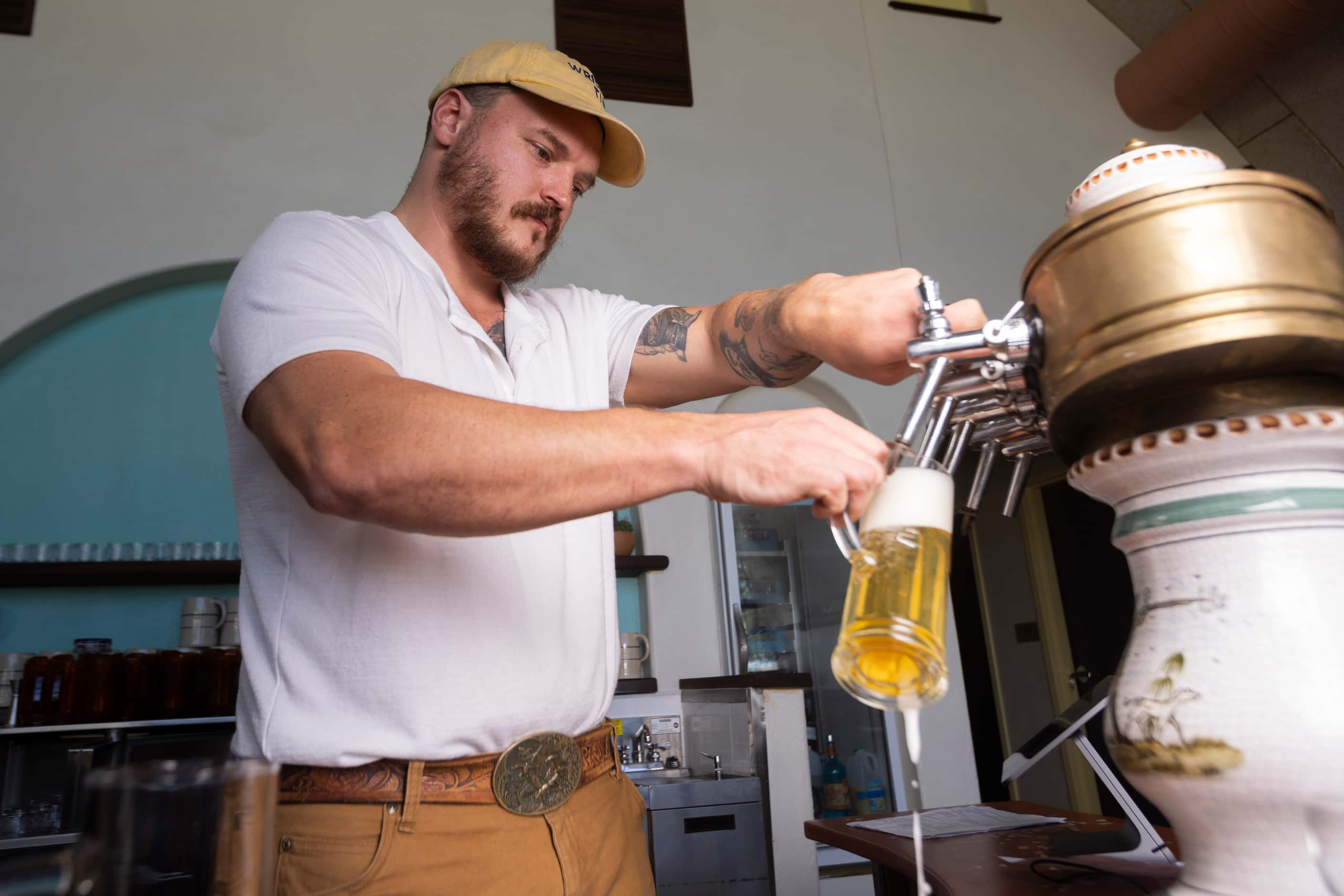 Owner and CEO Jacob Boger pours the Hart beer at the bar in the Wriggly Tin, a new bar near...