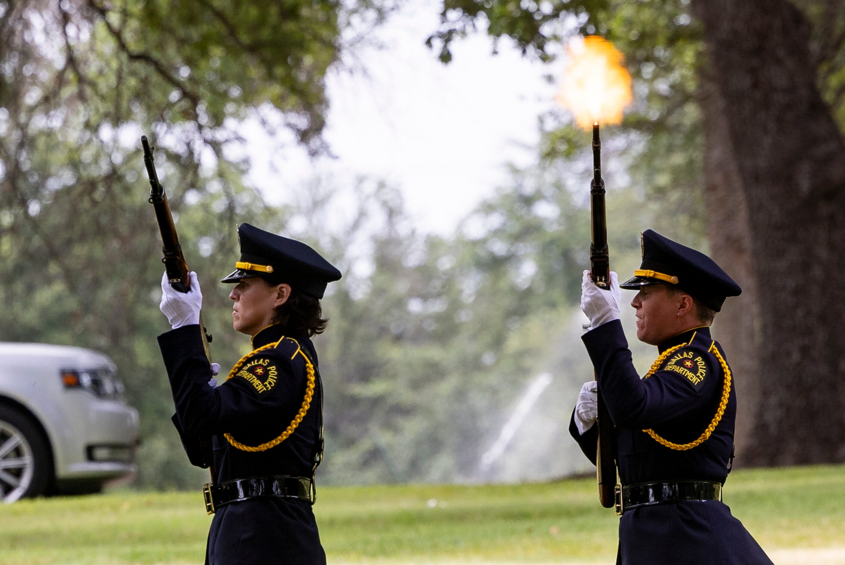 Members of the Dallas Police Honor Guard perform a 21-gun salute as the department renders...