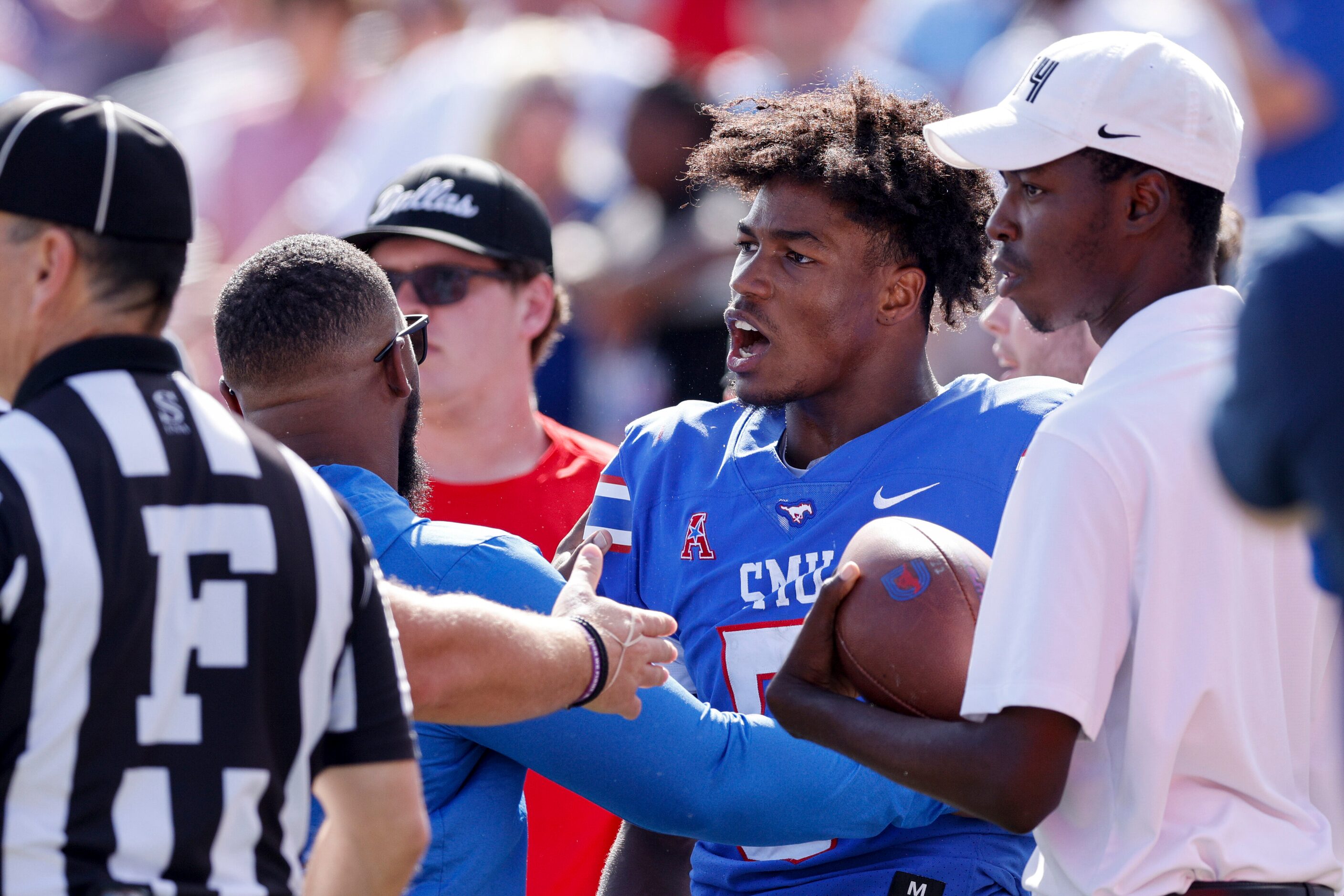 SMU wide receiver Moochie Dixon (5) exchanges words with a Cincinnati player during the...