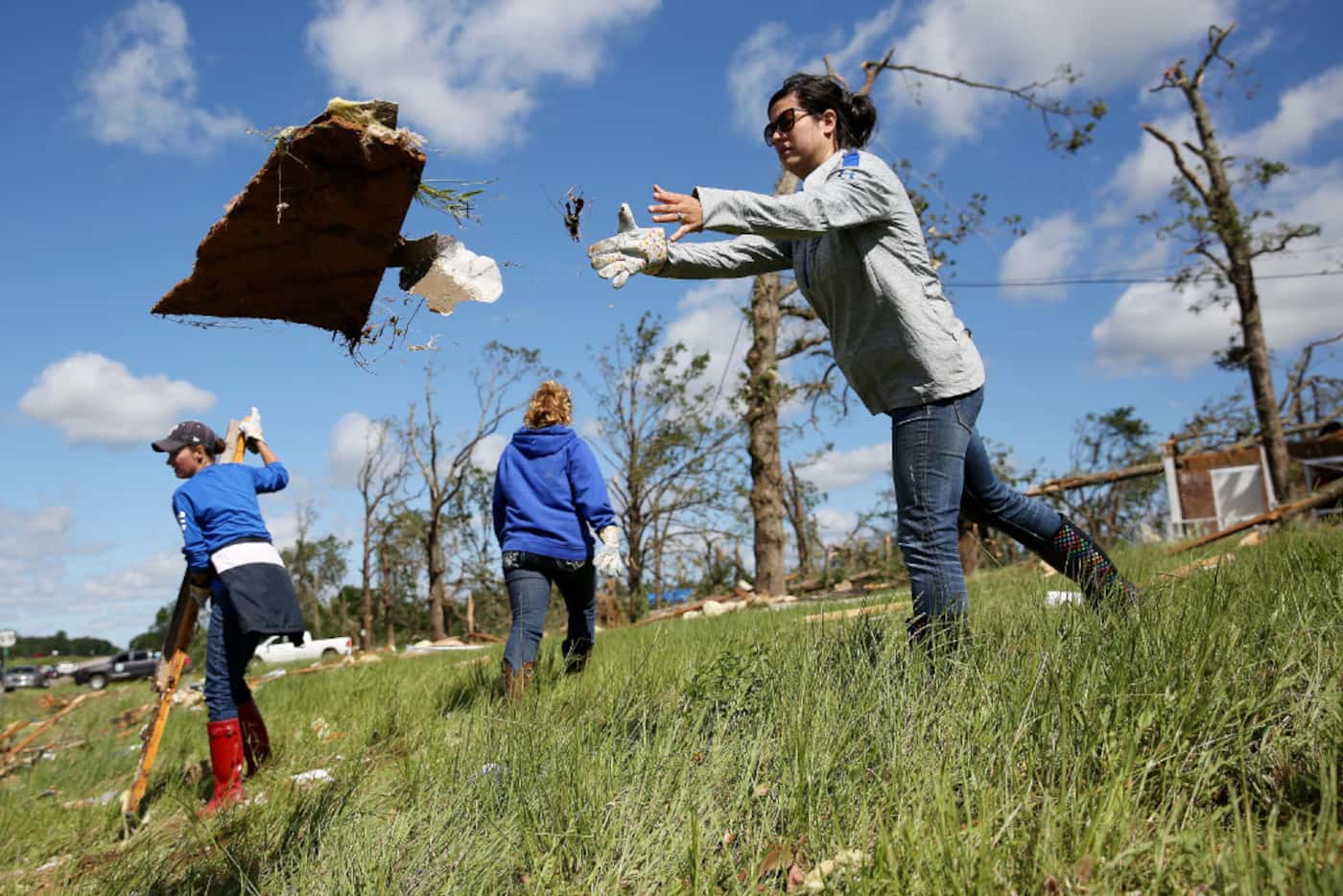 Sarah Jones, an Emory ISD teacher, helps to clean up debris along US-69 after a tornado...