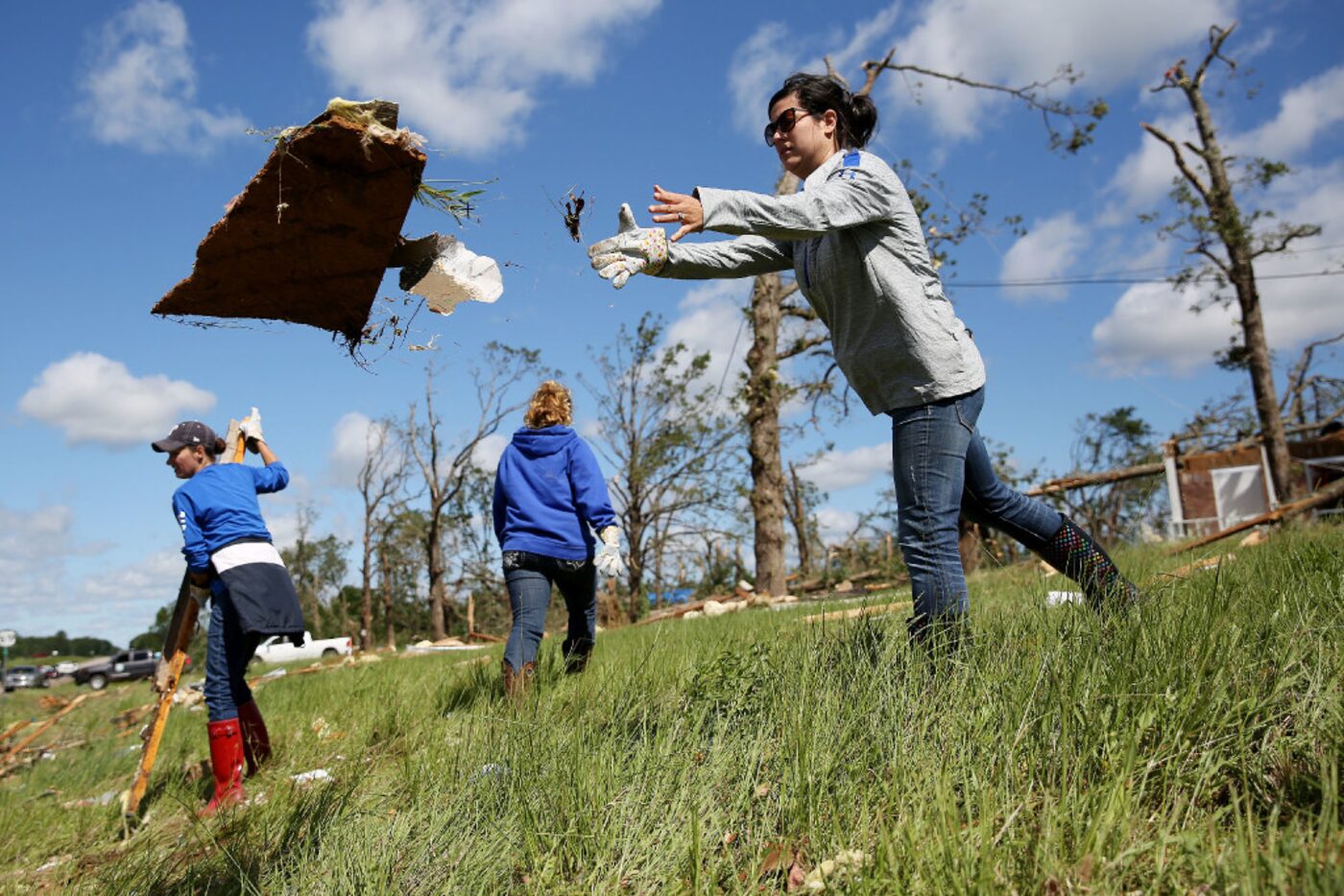 Sarah Jones, an Emory ISD teacher, helps to clean up debris along US-69 after a tornado...