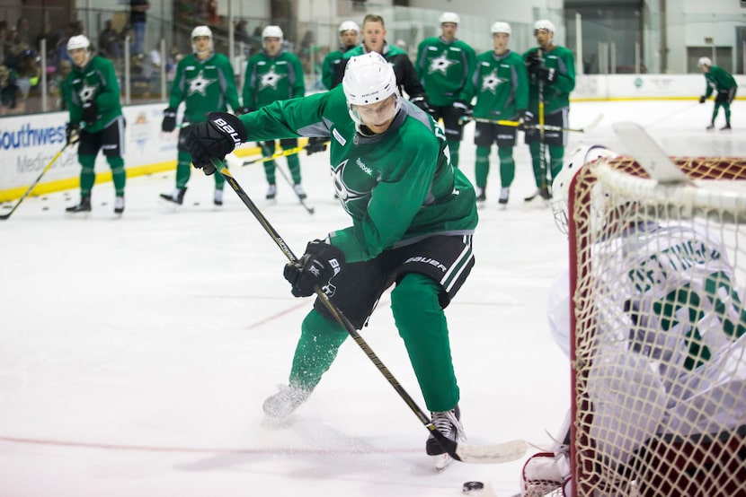 FILE - Forward Denis Gurianov works against goalie Jake Oettinger on the first day of Stars...