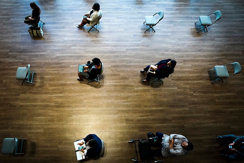 Chairs were spaced to ensure social distancing for city staff members watching a video feed...