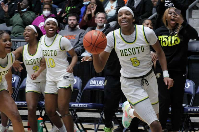 DeSoto guard Sa'Myah Smith (5) runs down the clock of the final seconds as she leads a...