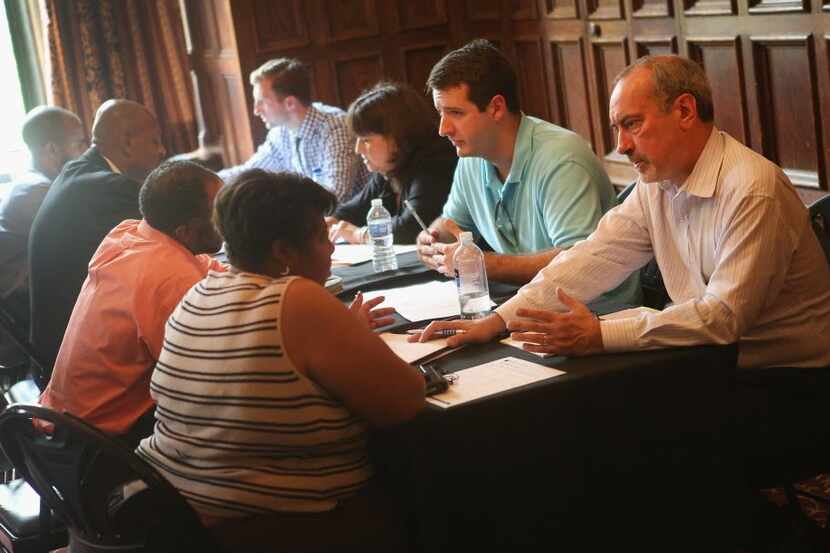  Military veterans (on left) last summer received help with their resumes and interview...