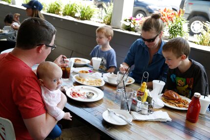 Jeremy Gorden holds Clara Gorden (left front) with Sean Gorden, 6, (from left back) Laura...