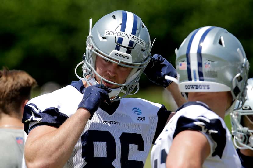 Cowboys rookie tight end Luke Schoonmaker (86) straps on his helmet as the Dallas Cowboys...