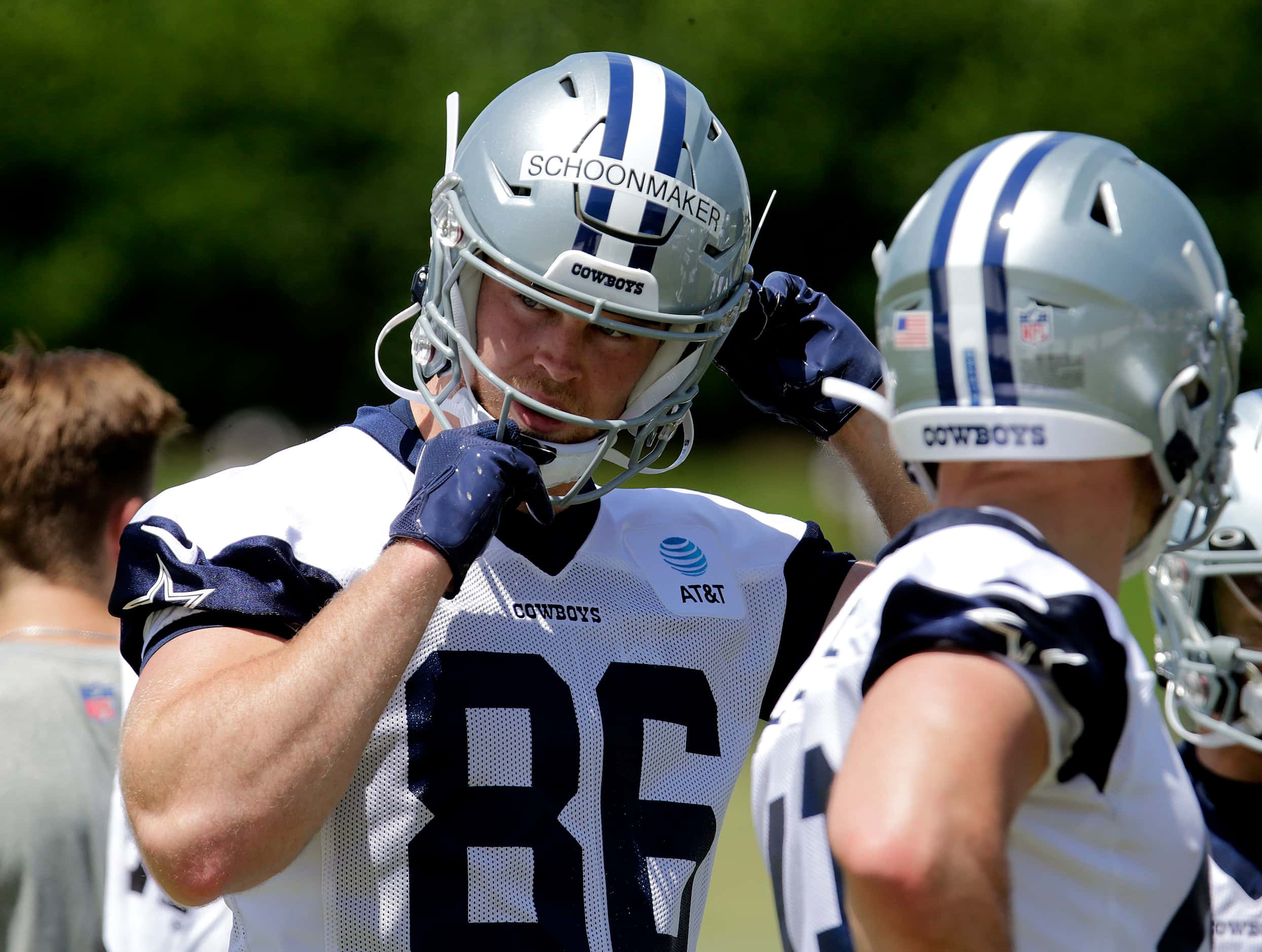 Cowboys rookie tight end Luke Schoonmaker (86) straps on his helmet as the Dallas Cowboys...