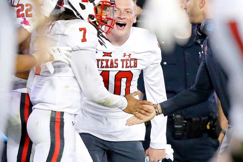 Texas Tech Red Raiders quarterback Jett Duffey (7) is congratulated by injured quarterback...