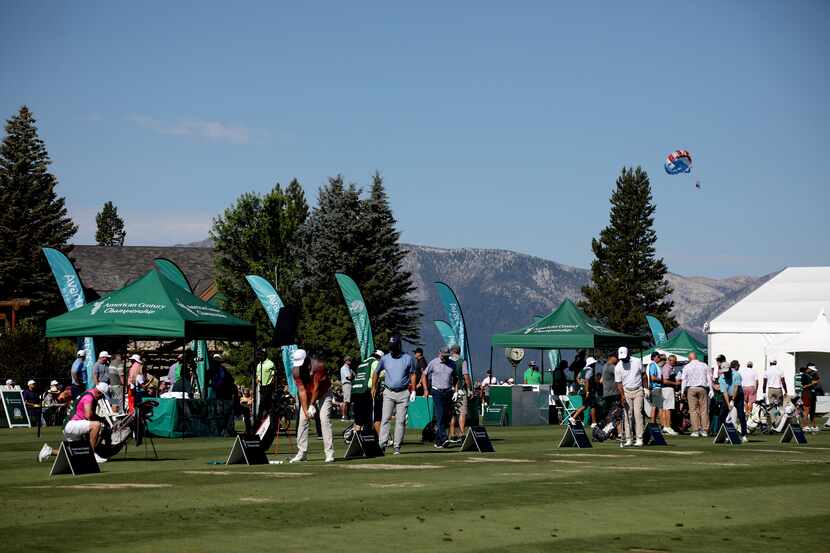 Golfers practice on the driving range during round one of the American Century Championship...