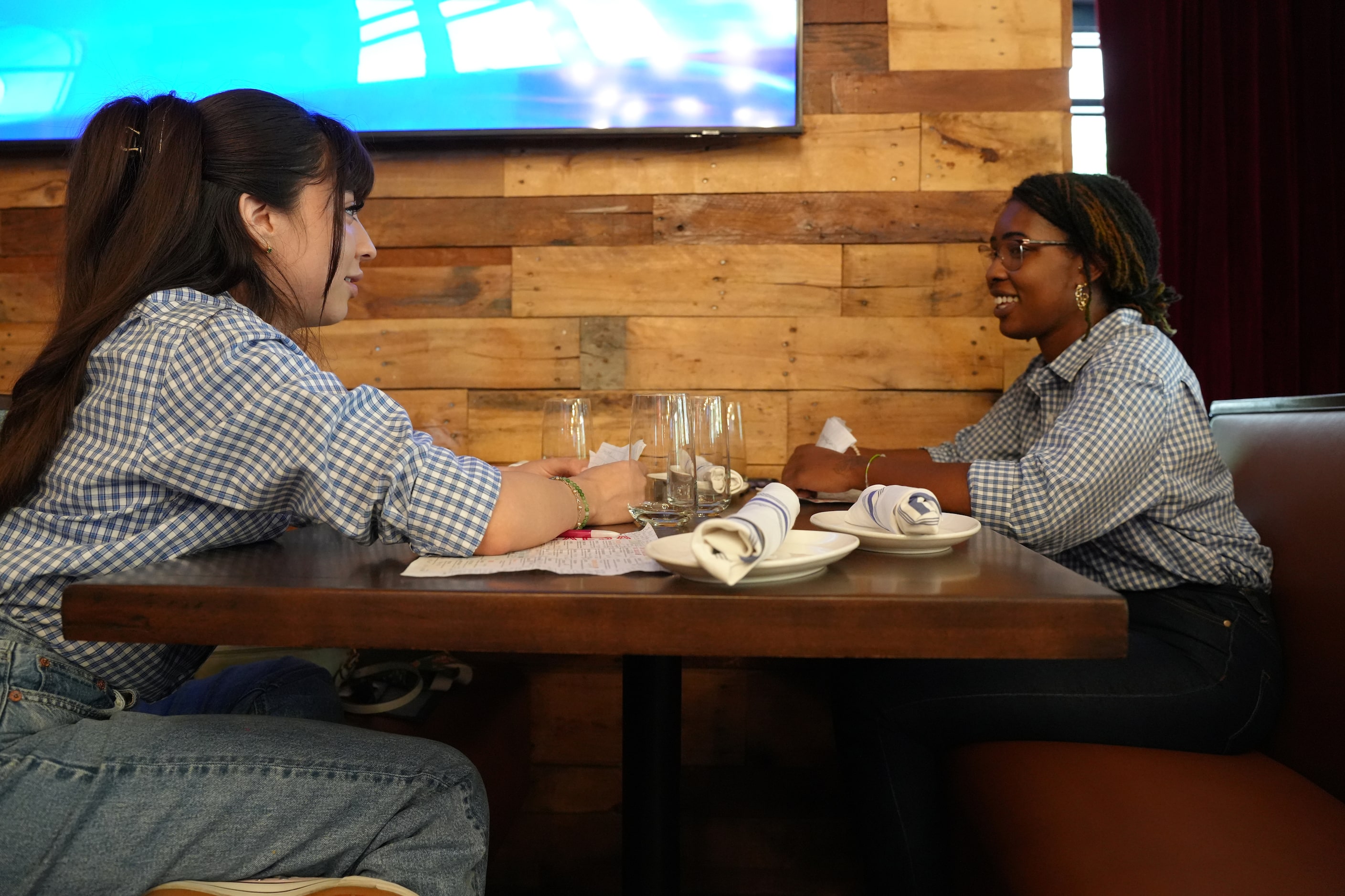 Servers Elianna Leon (left) and Arianna McCoy memorize the menu in preparation for the...