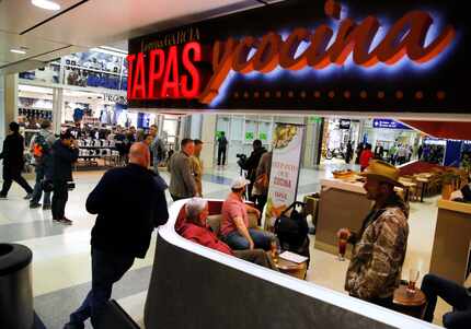 Airline passengers hang out in one of Terminal A's newest restaurants, Lorena Garcia Tapas Y...
