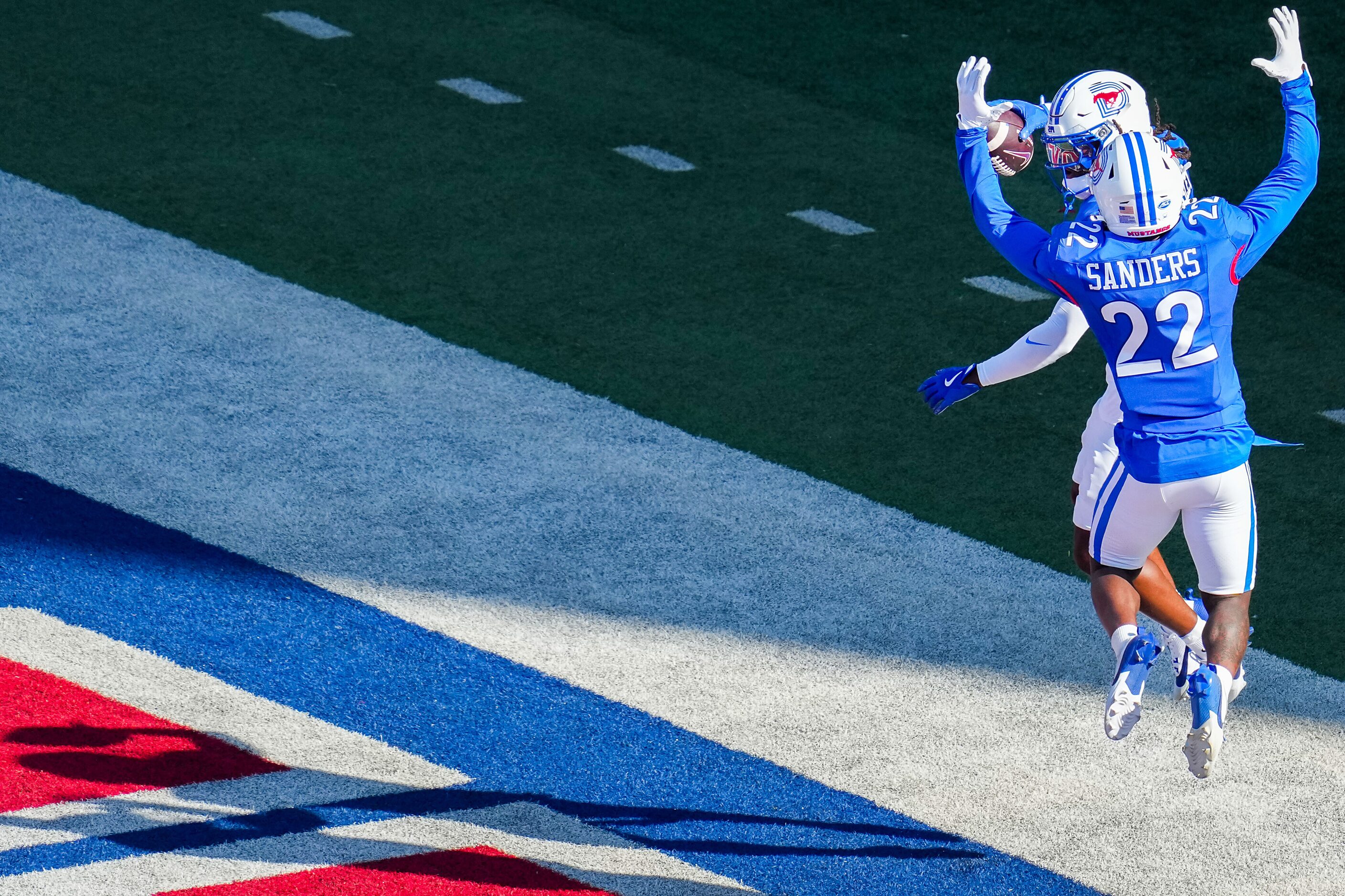 SMU safety Brandon Crossley (1) celebrates with Cale Sanders Jr. (22) after returning a...