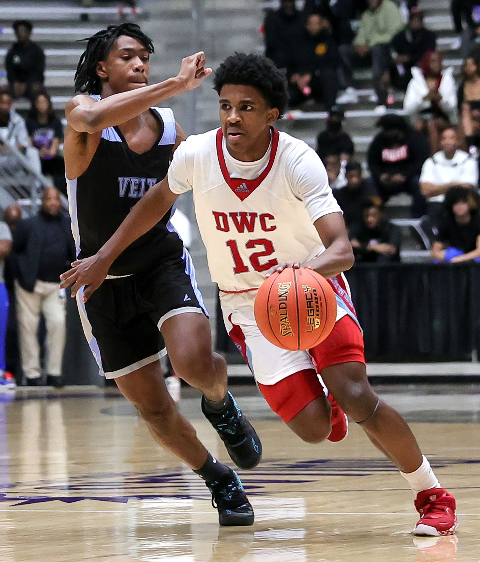 Carter guard Kyle Givens (12) tries to dribble past Roosevelt guard Nehemiah Dawn (L) during...