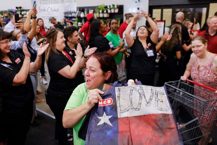 Michelle Kernohan of McKinney, lifting a H-E-B bag walks through the festivities during the...
