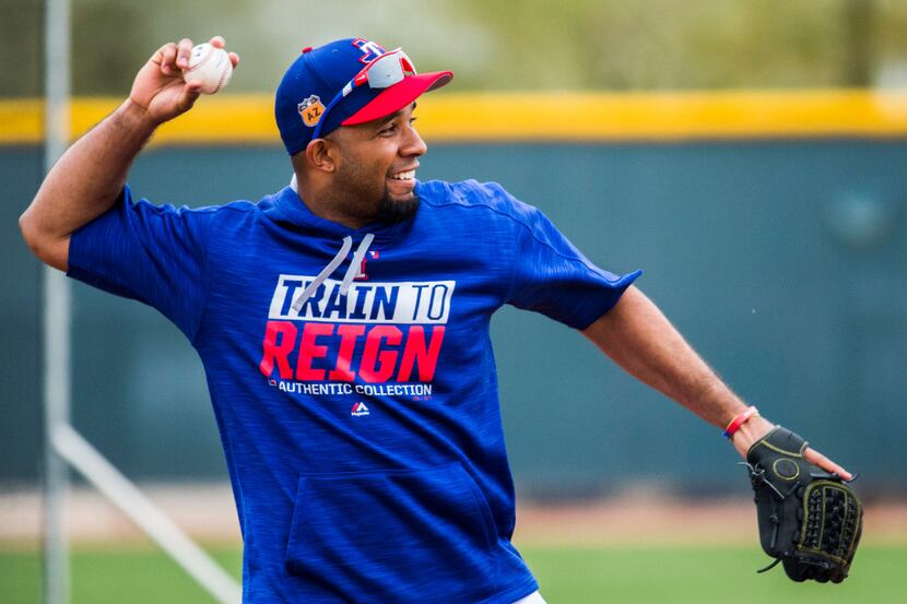 Texas Rangers shortstop Elvis Andrus (1) throws to first base during a spring training...