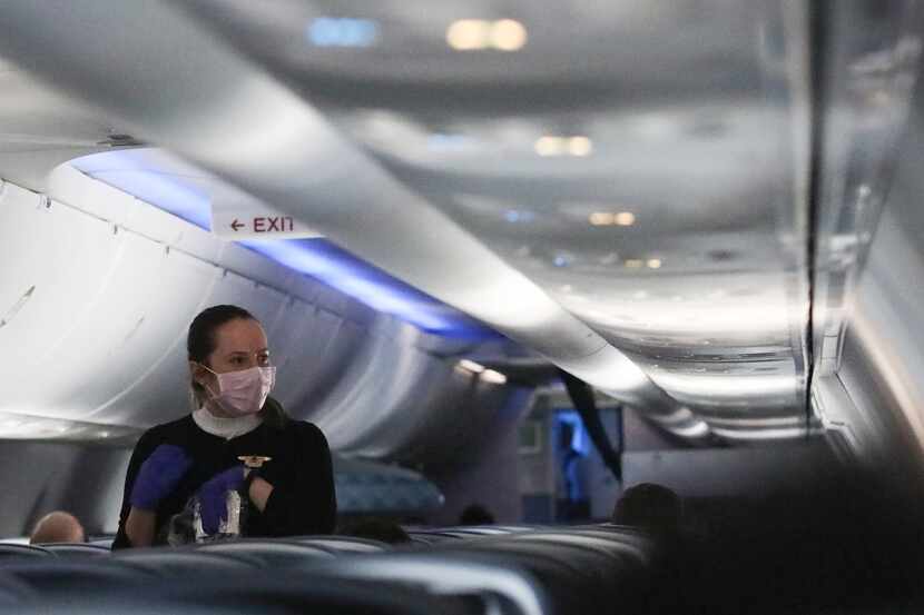 A flight attendant serves snacks on a Delta flight to Hartsfield-Jackson Atlanta...
