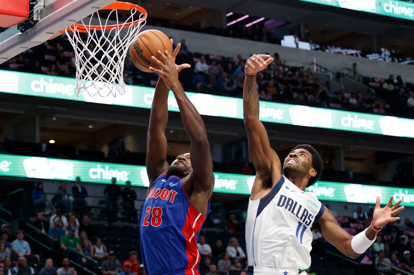 Detroit Pistons center Isaiah Stewart (28) and Dallas Mavericks guard Kyrie Irving (11) go...