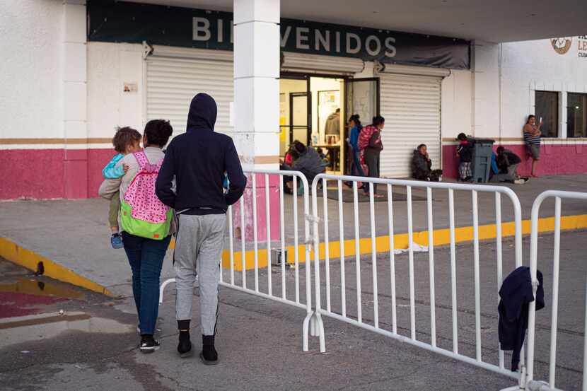 In February, migrants at the state-run migrant shelter walk into the shelter in Cd. Juarez,...