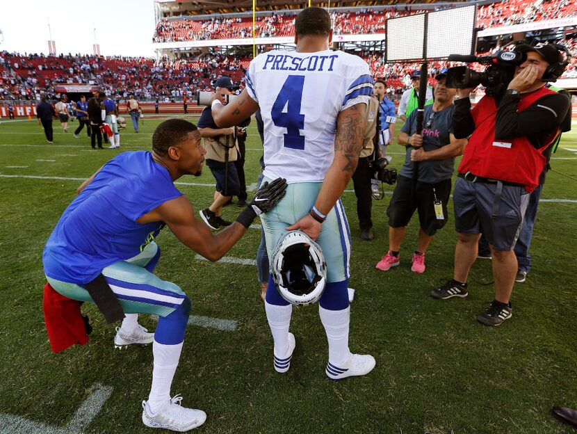 Cowboys wide receiver Terrance Williams (83) slaps rookie quarterback Dak Prescott (4) on...