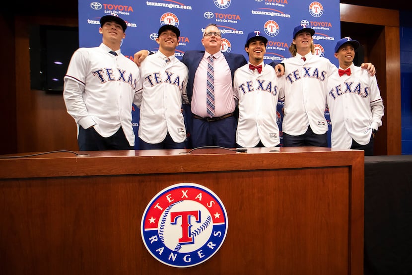 Texas Rangers Senior Director of Amateur Scouting Kip Fagg (center) poses for photos with,...